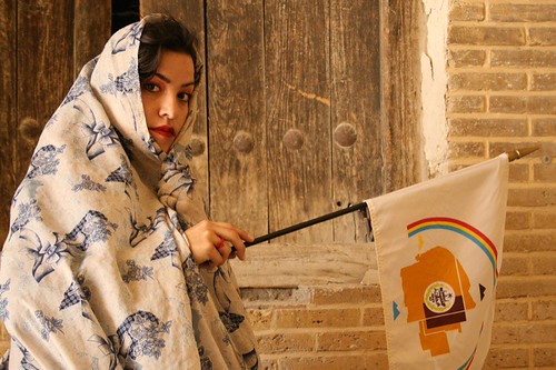 Michelle in chador with flag of the Navajo Nation