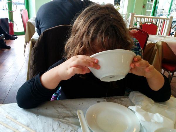 Poesy finishes her Pho, Song Que, Hackney, London, UK